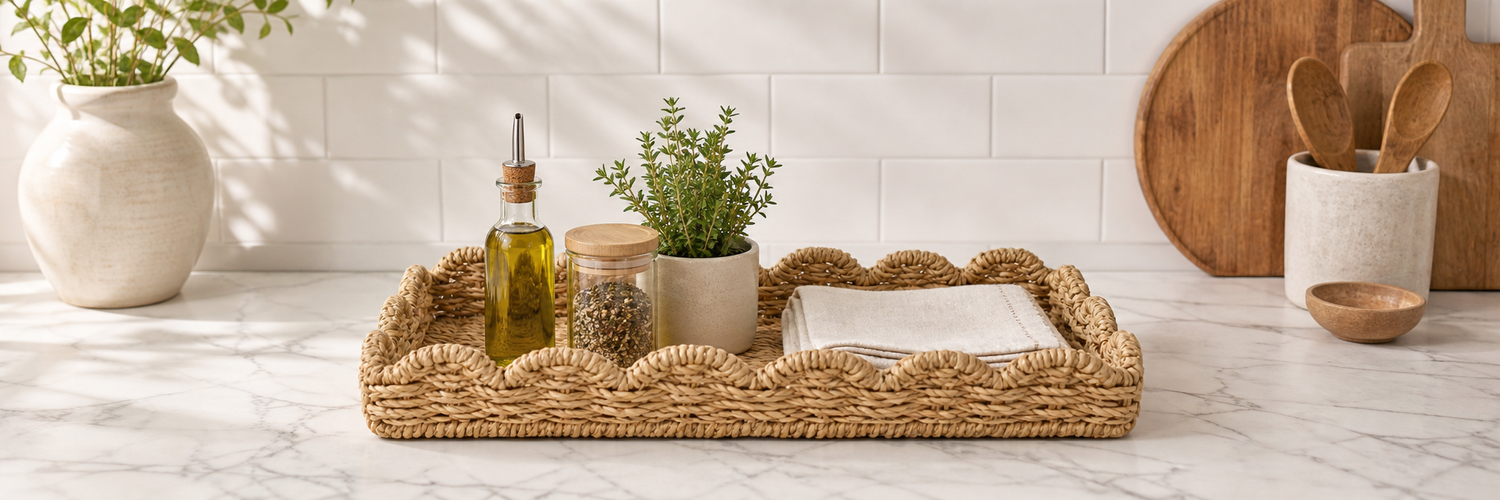 Wicker seagrass tray styled on a kitchen counter with olive oil, spice jar and herb — Savvy &amp; Sorted