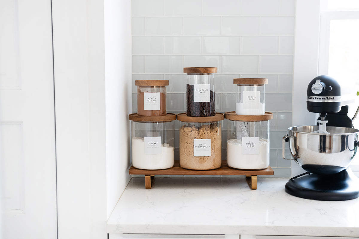 Organized pantry baking station with labeled glass canisters and KitchenAid mixer - Savvy & Sorted