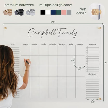 Person using a large family planner with measurements and design color options displayed.