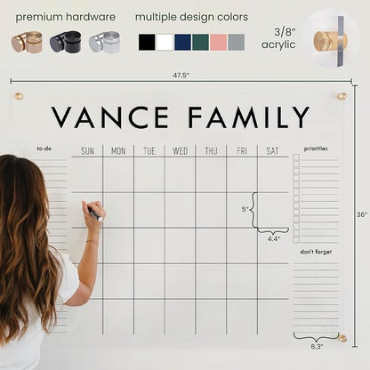Person using a large family calendar with &