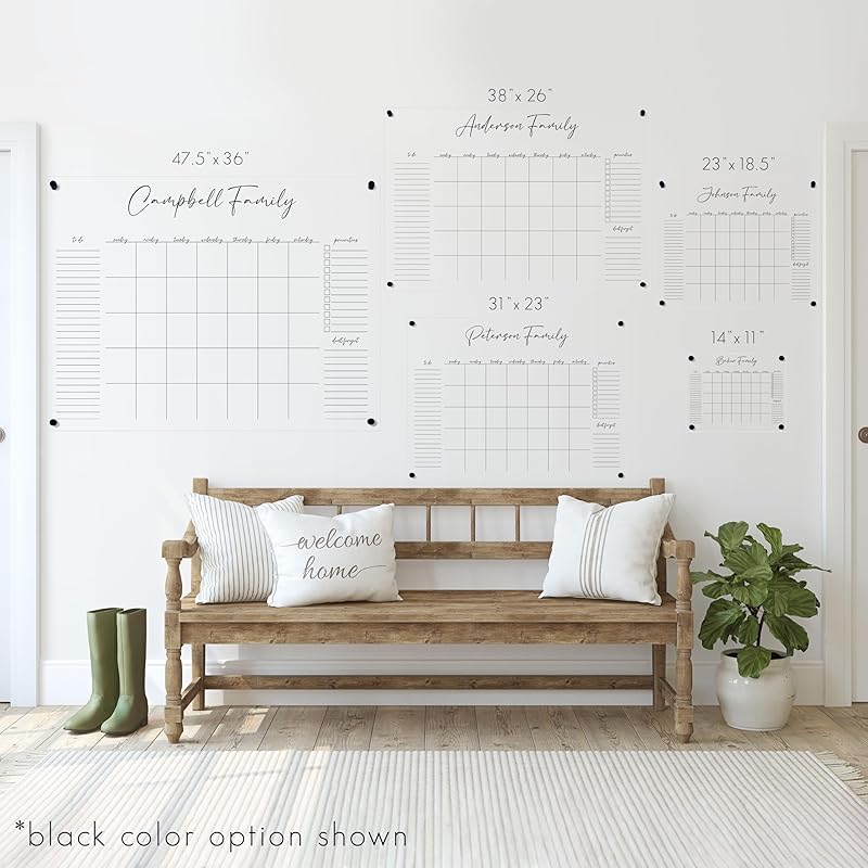 Wooden bench with decorative pillows in a room with a white wall featuring printed family tree charts.