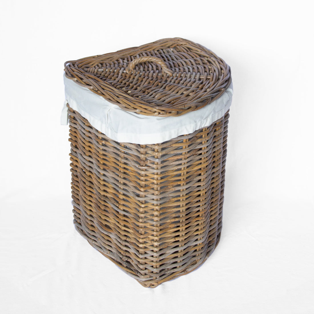 A rectangular wicker laundry hamper with a lid, featuring a natural brown woven body, a white fabric liner, and a small top handle, photographed on a white background.