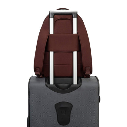 Brown backpack attached to a gray suitcase on a white background