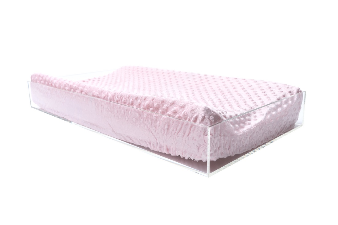 Pink mattress protector on a white background
