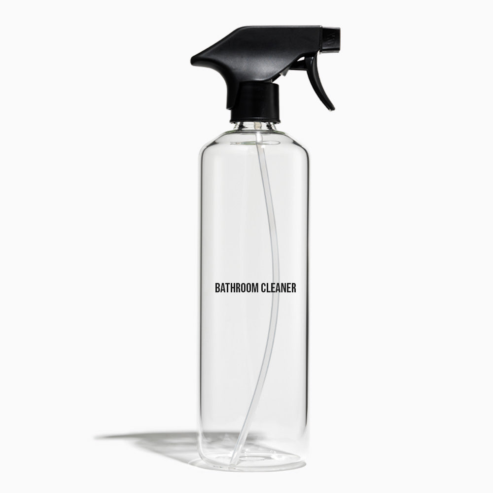 A clear plastic spray bottle with a black trigger sprayer and a clear internal tube, labeled &