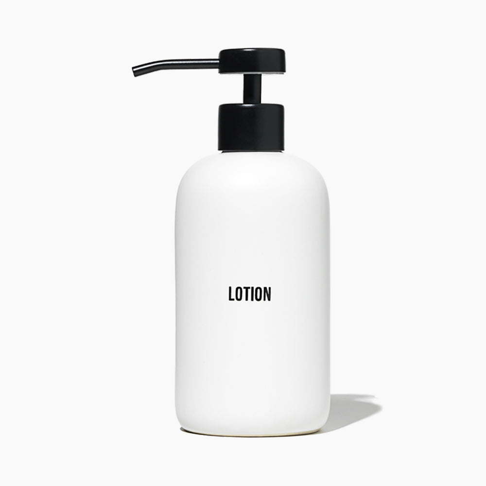 A minimalist white hand soap dispenser bottle with a black pump and the words &